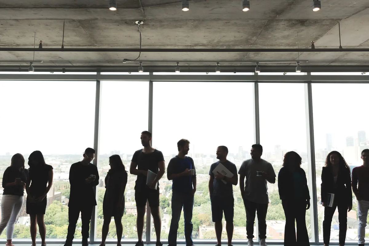 A team gathered along an office window